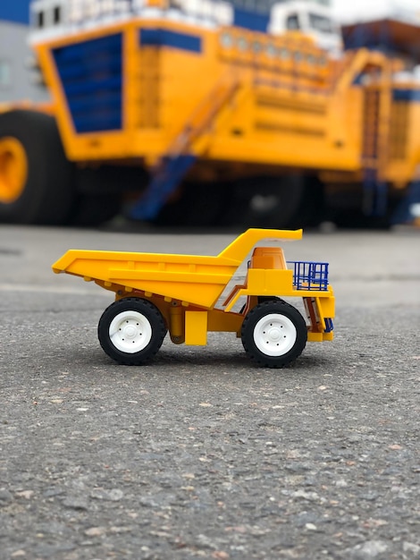 Close-up of yellow toy car on road