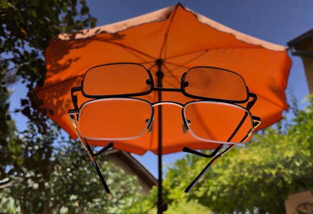 Close-up of yellow umbrella against orange sky