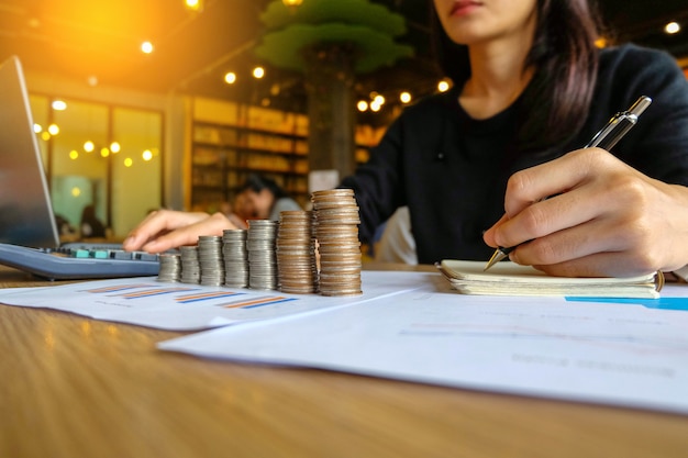 Close up of yong asian female business owner making calculations. Savings and finances con