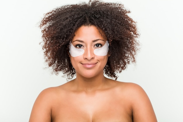 Close up of a young african american woman with an eye skin treatment