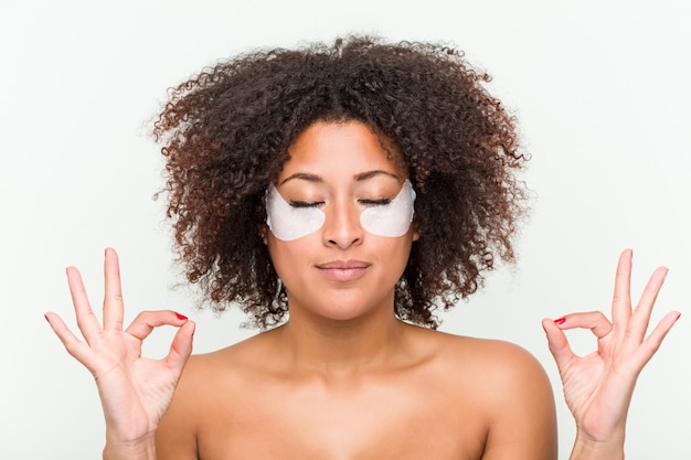 Close up of a young african american woman with an eye skin treatment