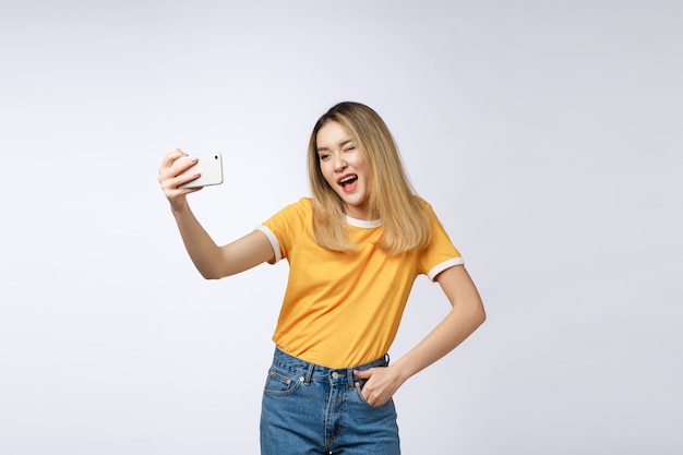 Close-up of young Asian beautiful woman taking selfie