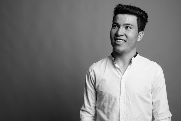 Close up of young Asian businessman wearing white shirt