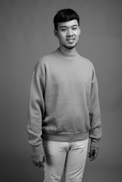 Close up of young Asian man wearing sweater