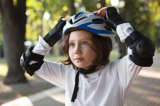 Close up of a young boy in sports helmet, looking shocked