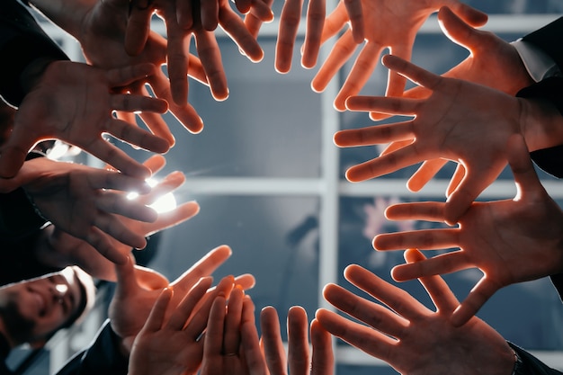 Close up. young business team standing in a circle. concept of teamwork.