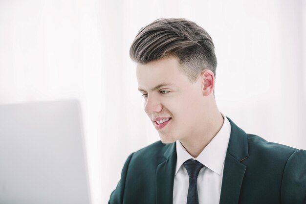 Close up young businessman working on laptop