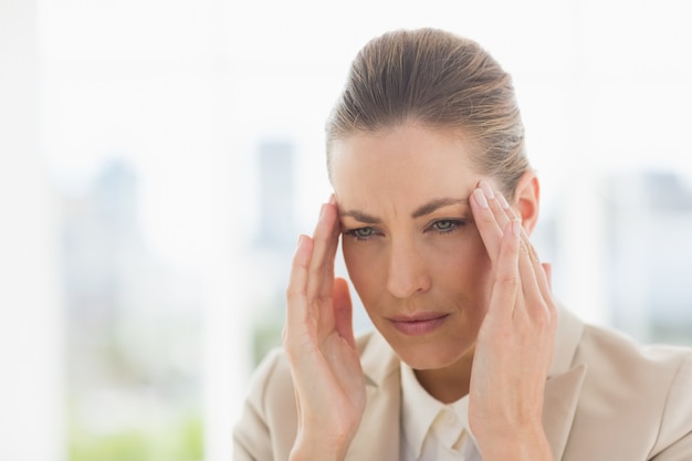 Close-up of a young businesswoman with headache