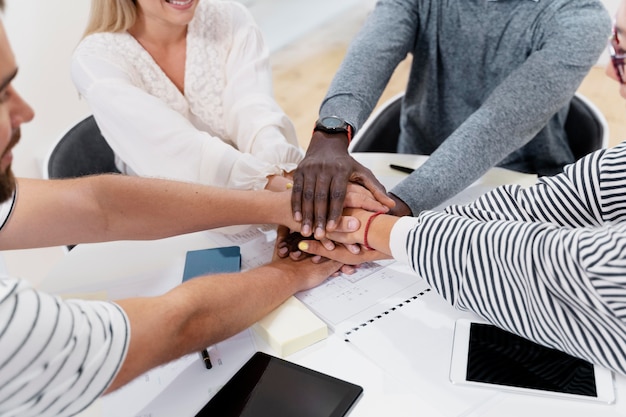 close up on young colleagues hands in a meeting