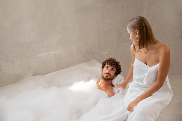 Close up on young couple taking a bath