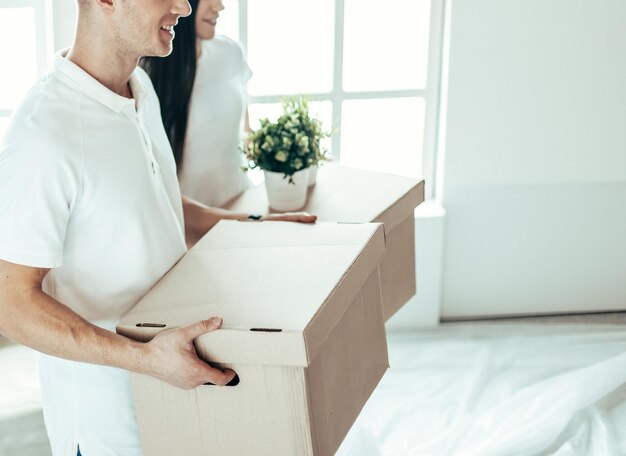 Close up a young couple with boxes in a new apartment