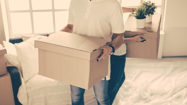 Close up a young couple with boxes in a new apartment