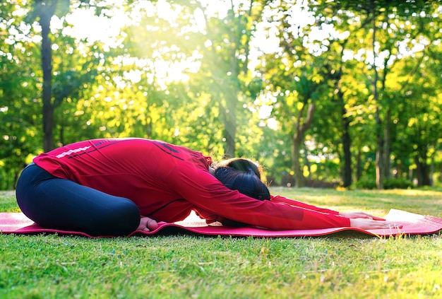 Close up of young femal do yoga in the park