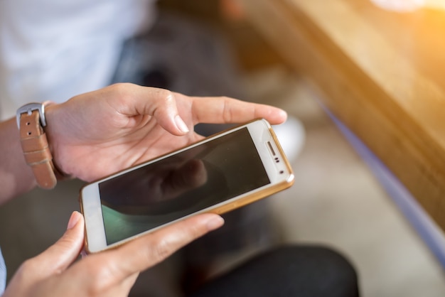 Close-up Of Young  female Playing Video Game On Mobile