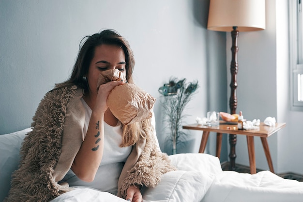 Close-up of a young girl blowing into a paper bag