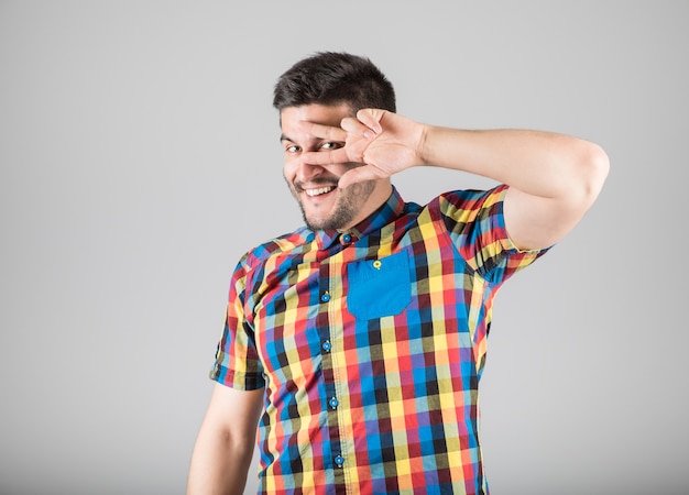 Close up on young guy making gesture isolated