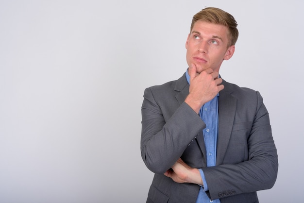 Close up of young handsome businessman with blond hair isolated