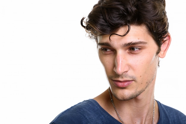 Close up of young handsome man thinking while looking down