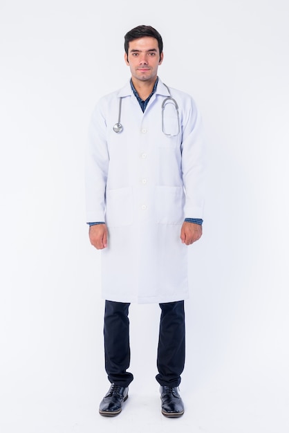 Close up of young handsome Persian man doctor isolated