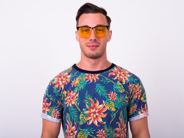 Close up of young handsome tourist man ready for vacation isolated