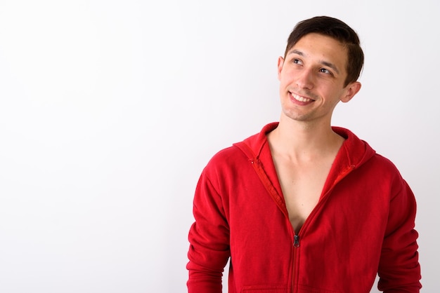 Close up of young happy man smiling and thinking while looking u