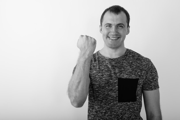 Close up of young happy muscular man smiling while looking motivated