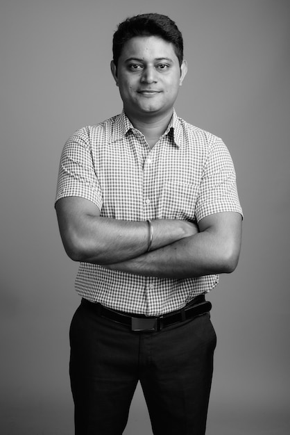 Close up of young Indian businessman wearing checkered shirt 