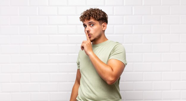 Close up on young man asking for silence