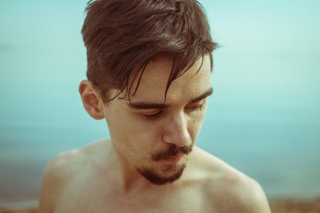 Close-up of a young man looking away