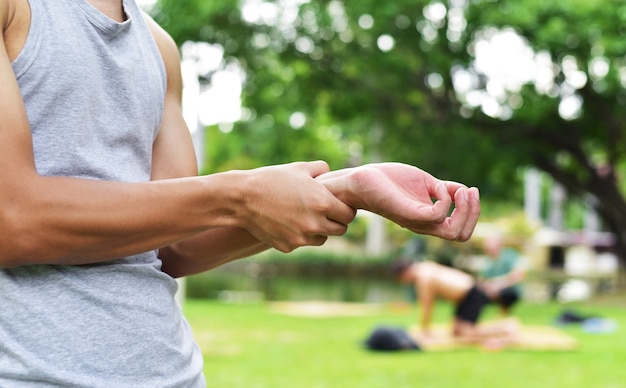 close up young man runner has injury or pain at writs joint or arm muscle