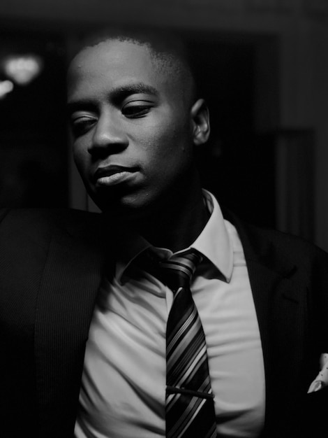 close-up of young man in suit at darkroom