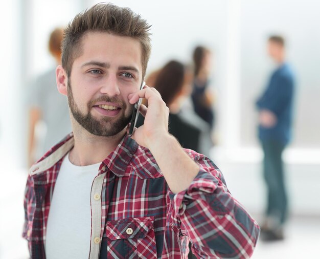 Close up young man talking on a smartphone