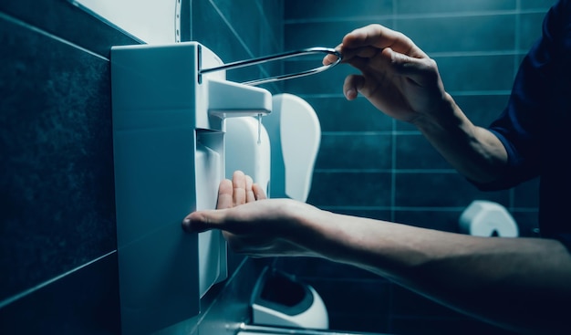 Close up young man using a bactericidal hand wash