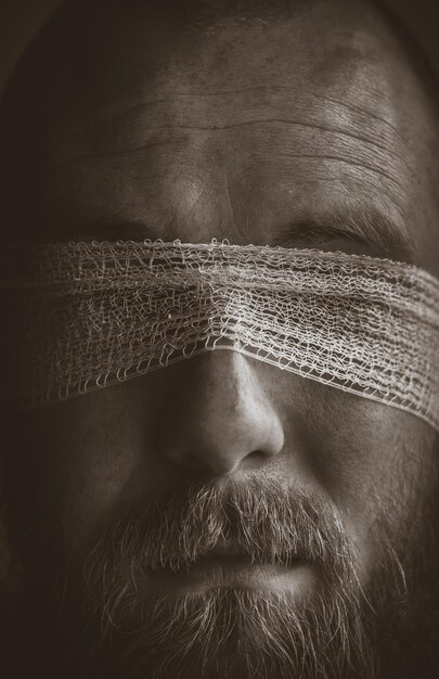 Photo close-up of young man with fabric on eyes