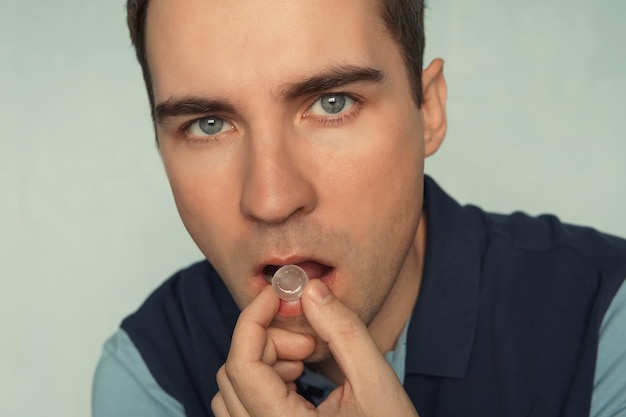 Close  up of a young man with a tablet in his hands to freshen his breath