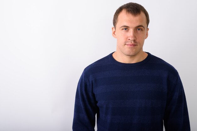 Close up of young muscular man against white background