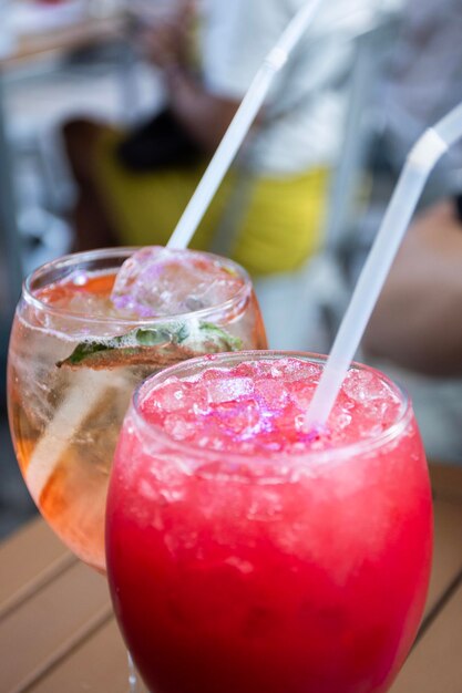 close up of young red and rosatto cocktail glasses on bistro table with crushed ice