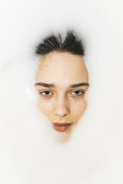 Close-up of young woman against white background