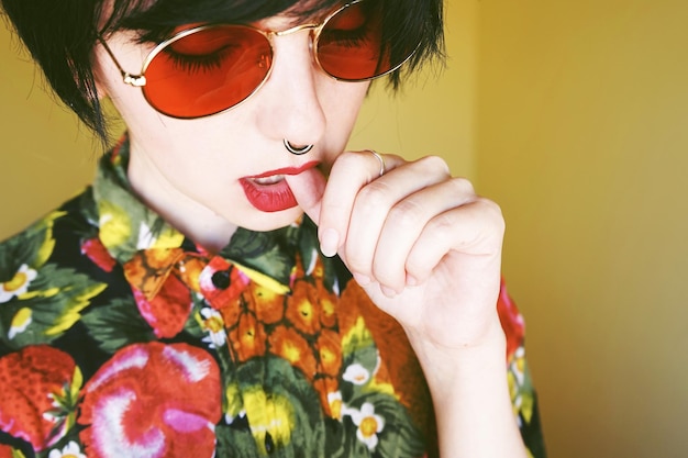 Close-up of young woman biting thumb