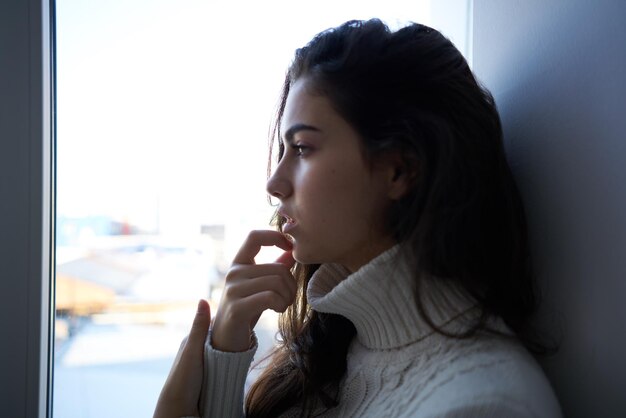 Close-up of young woman blowing bubbles at home