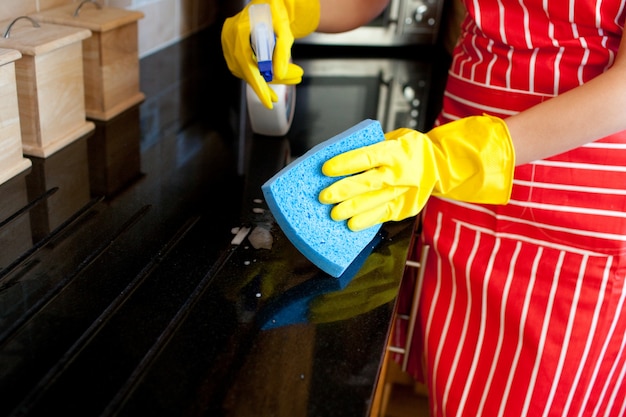 Close-up of a young woman doing housework