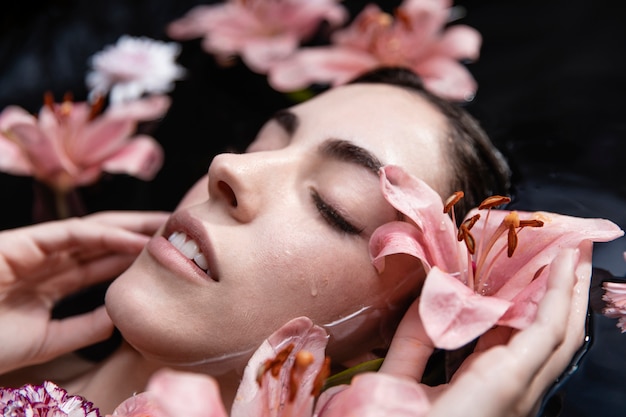 Close-up young woman enjoying spa treatment