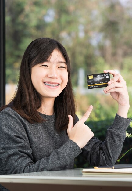 Close up young woman holding credit card