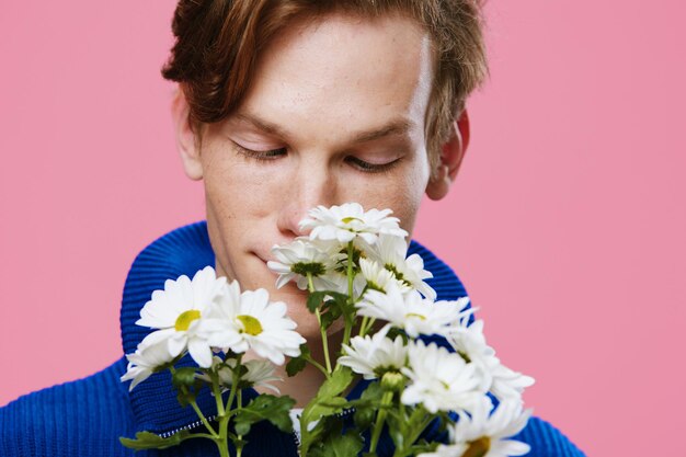 Close-up of young woman holding flower