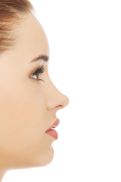 Photo close-up of young woman looking away against white background