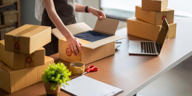 Close up young woman seller prepare parcel box of product for deliver to customer Online selling ecommerce Young woman working online ecommerce shopping at her shop