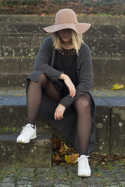 Close-up of young woman sitting on bench