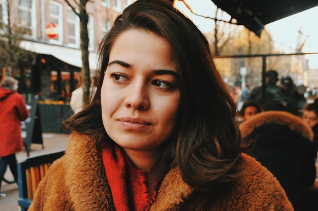 close-up of young woman sitting at cafe