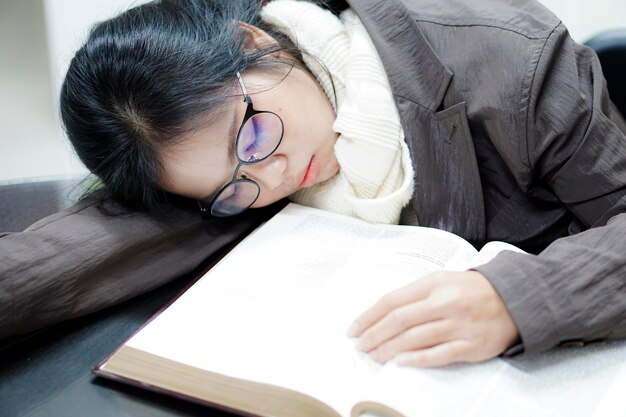 Close-up of young woman sleeping on desk