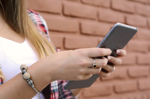 Close Up of a young woman using her tablet.